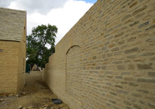 Retaining Wall Clad in Cotswold Stone with Segmental Arch